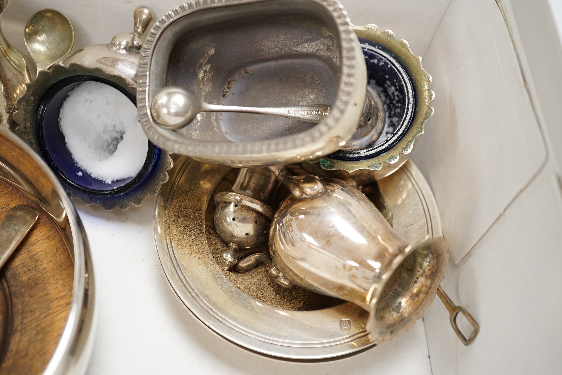 A pair of modern silver decanter coasters, London, 1973 and a collection of silver condiments etc. Condition - poor to fair